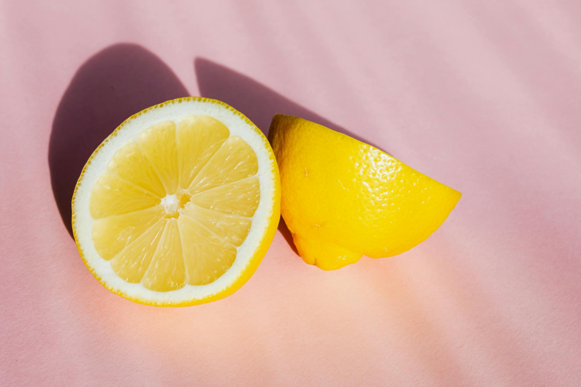 A teal lemon vibrator on smooth white silk fabric