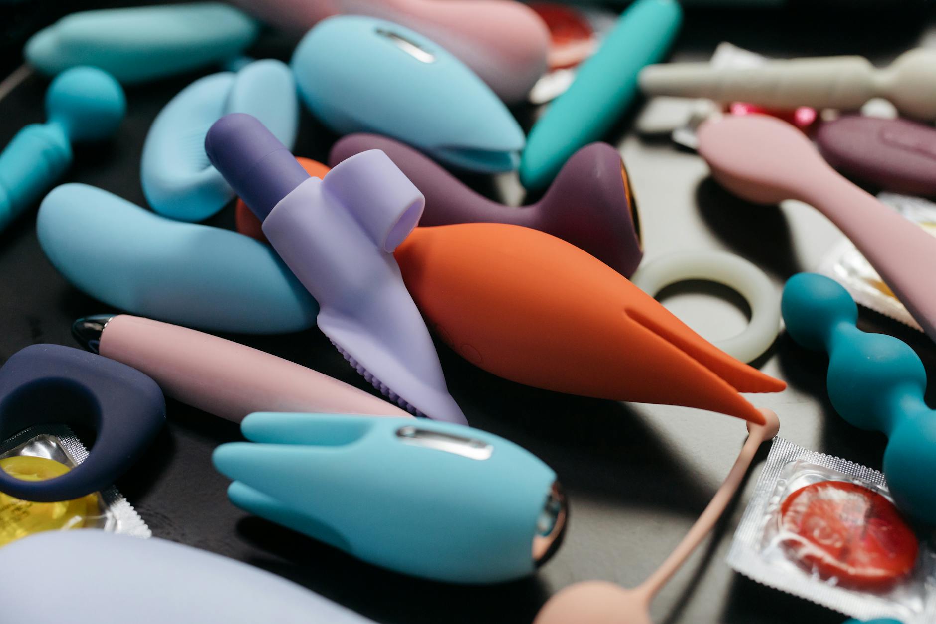 A close-up display of colorful vibrators and intimate wellness products