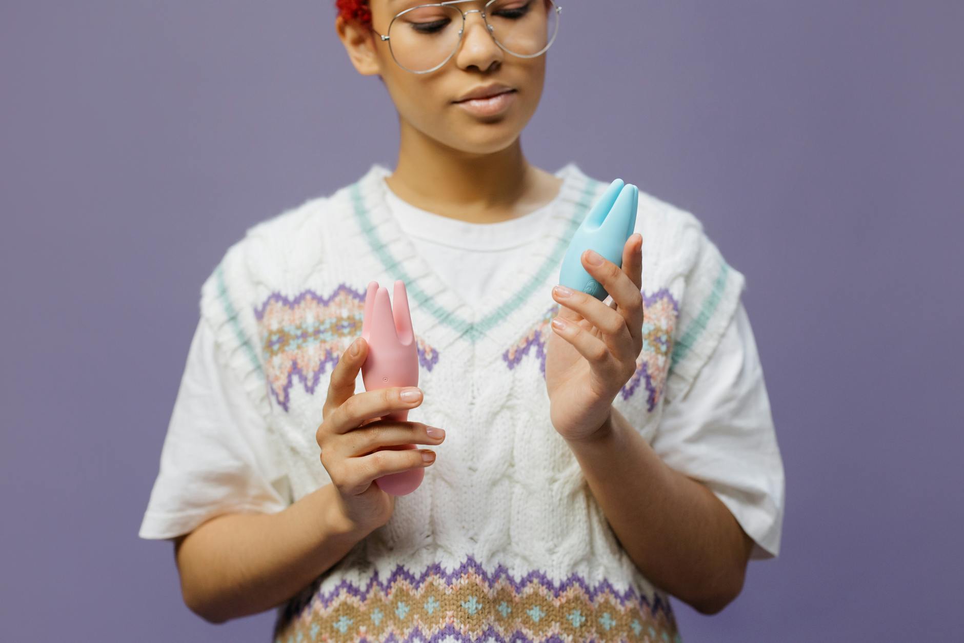 Woman holding lemon clitoral vibrators with curiosity and confidence